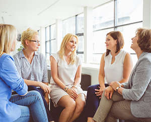 five women sitting and talking