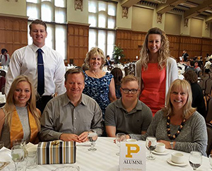 A group of brunch attendees posing for a photo at their table